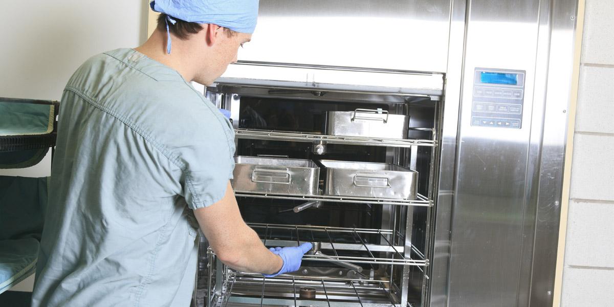 A health care professional removes sterile supplies from cart.